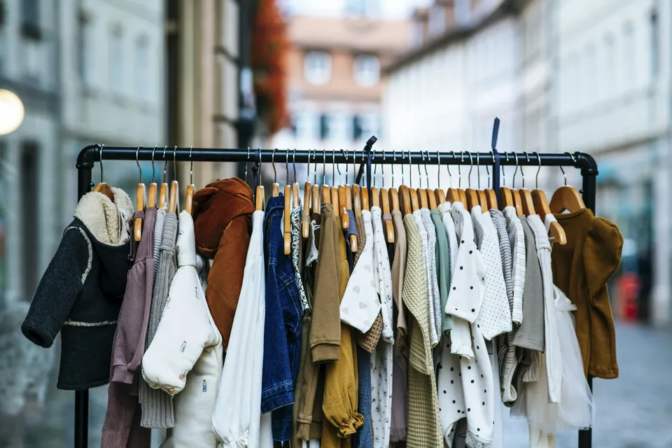 A clothes rail holding a small, simple selection of everyday clothes
