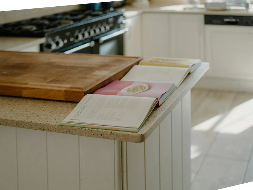 Open cookbooks resting on a kitchen counter