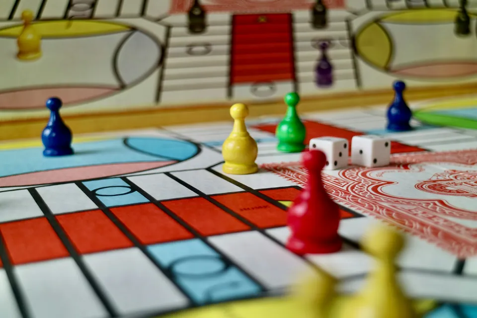 Colorful game pieces and two dice on a board game