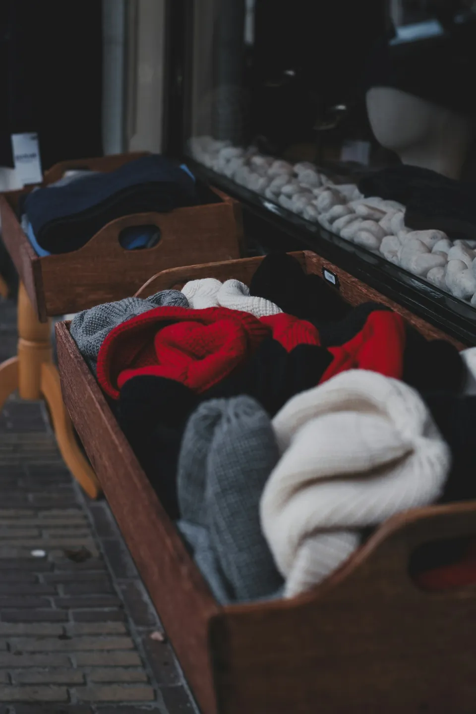 Wooden crates filled with knitted hats and scarves